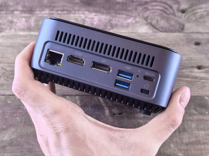 mini itx gaming pc on a desk next to a monitor