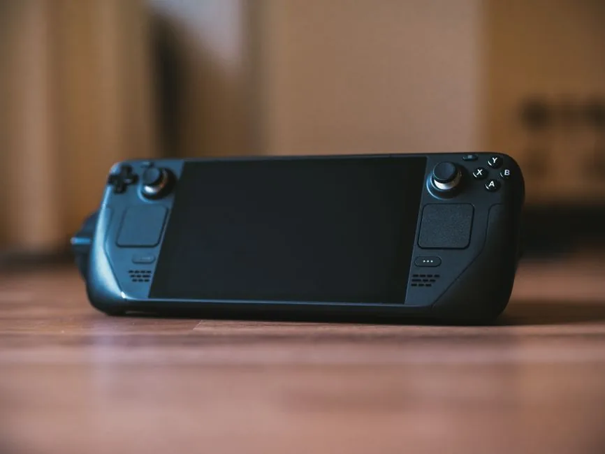 A handheld gaming PC showing a battery indicator while playing