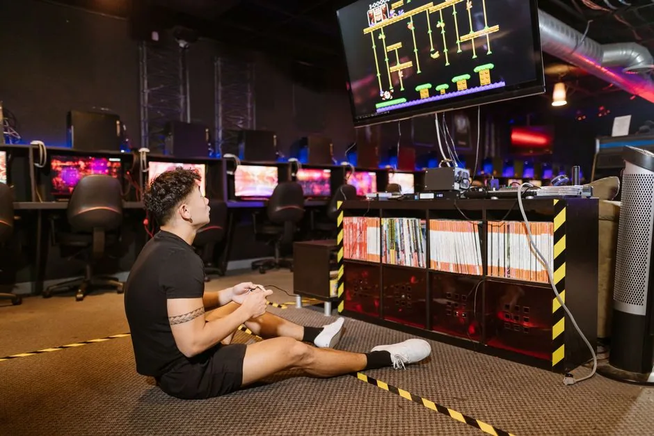 gamers comparing a console and pc setup in a modern arcade