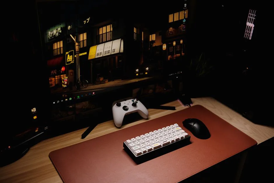 A tidy budget gaming desk setup with a keyboard and controller
