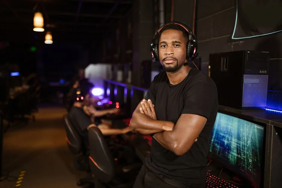 standing desk raised to standing height with a gaming monitor, keyboard, and headset
