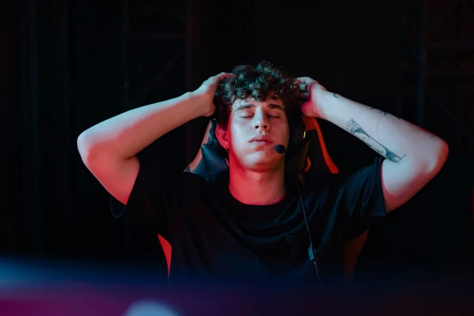 gamer wearing a headset next to a studio microphone rig