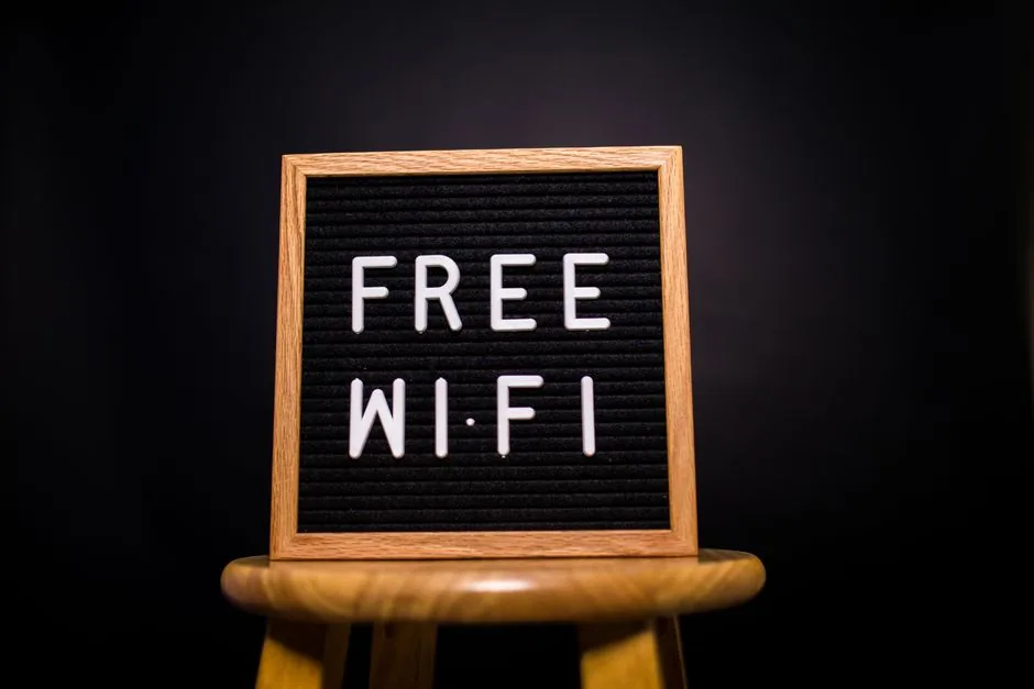 wooden sign advertising free wi-fi in a dark room