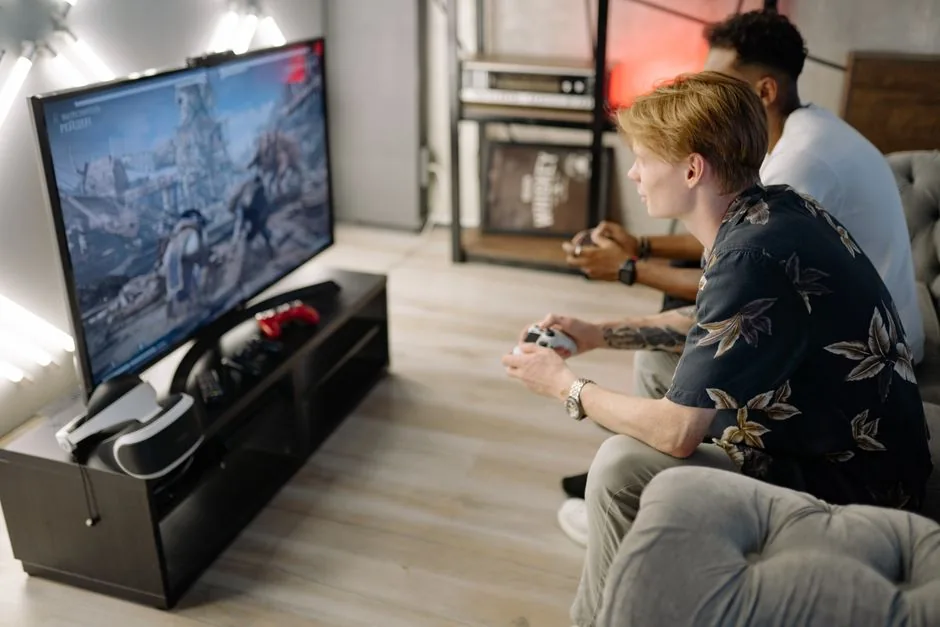 A modern living room gaming setup with a console and a large TV on a stand