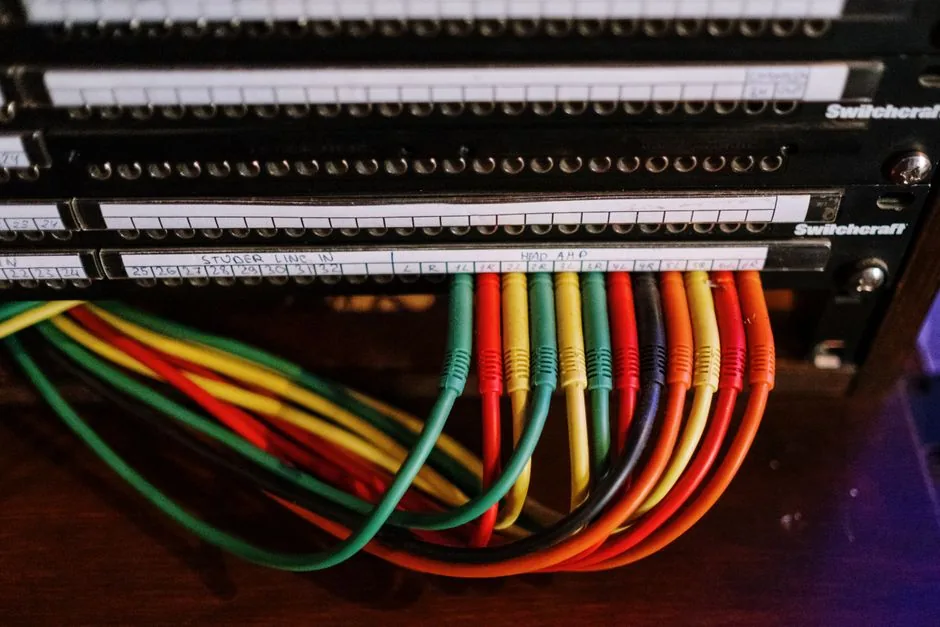 A close-up of cables bound with velcro ties running neatly along the underside of a desk